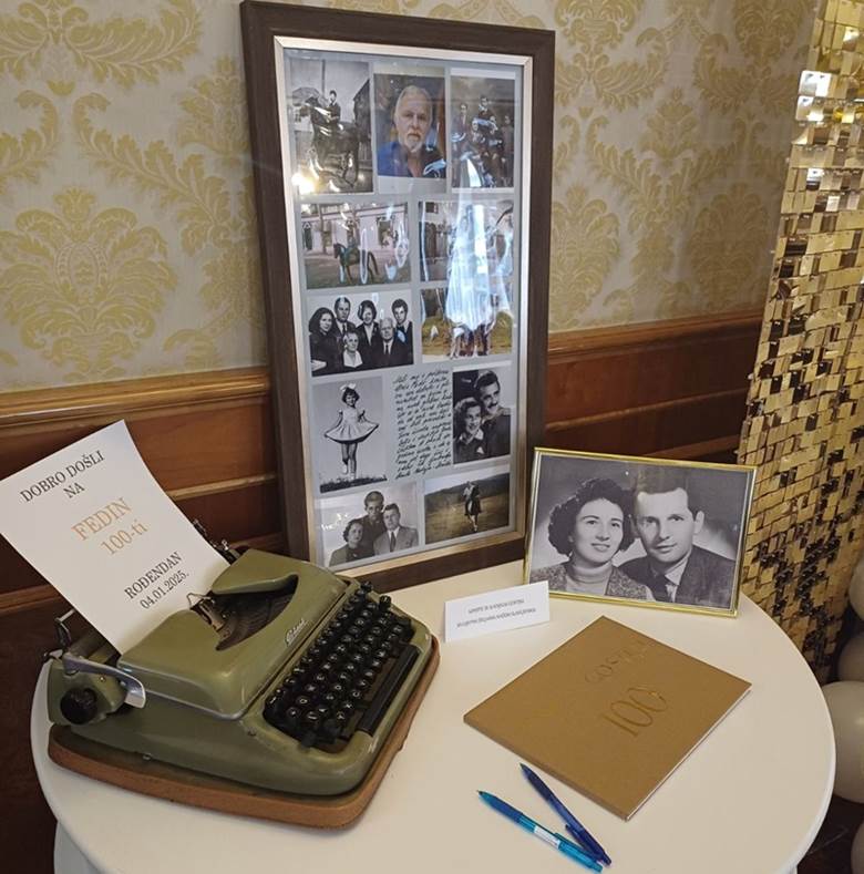 A typewriter and a picture frame on a tableDescription automatically generated